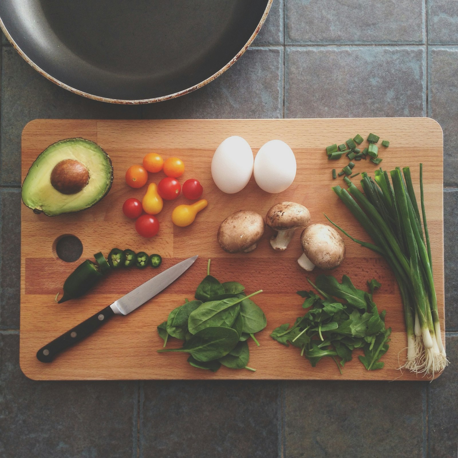 Fresh produce and eggs on a cutting board