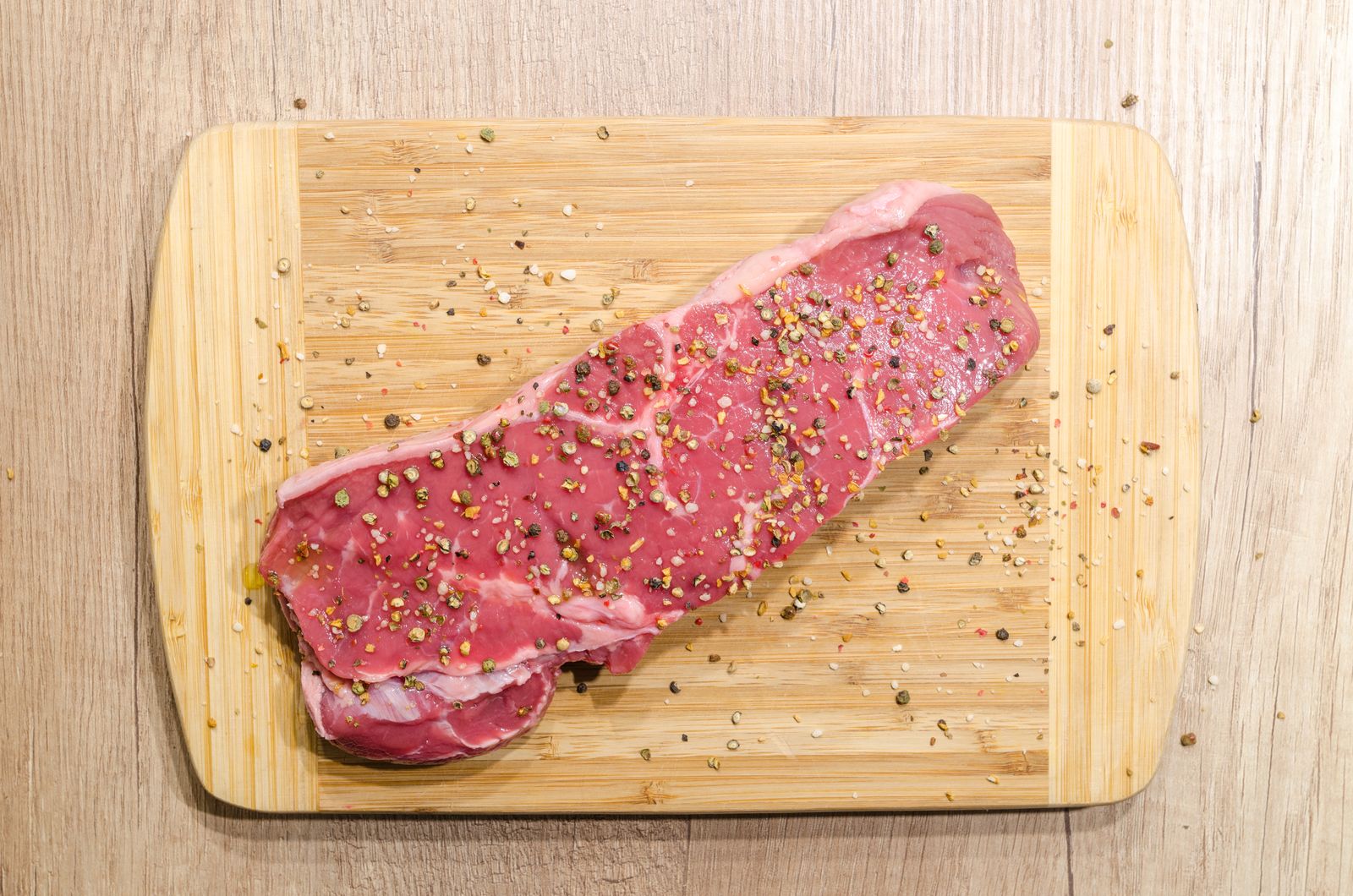 Seasoned striploin on light wood